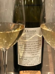 Bottle of Quivira blend of Roussanne Viognier between two glasses of wine