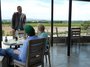 Wine tasters listening to a winery staff member talk
