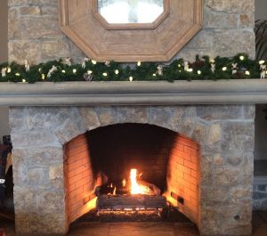 Holiday decorated stone fireplace