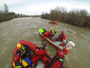 Firefighters doing a rescue in boats on the flooded Russian River.