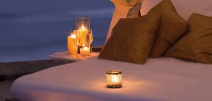 Romantic setting with a bed and candles.