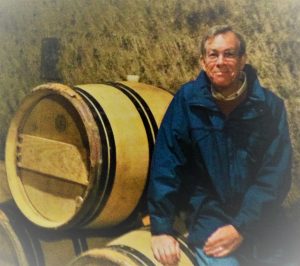 Michael Westrick sitting on a stack of barrels