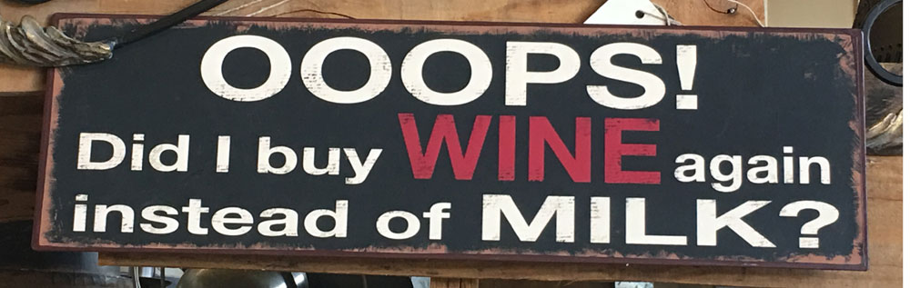 Sign that reads "Ooops! Did I buy Wine again instead of MIlk?"