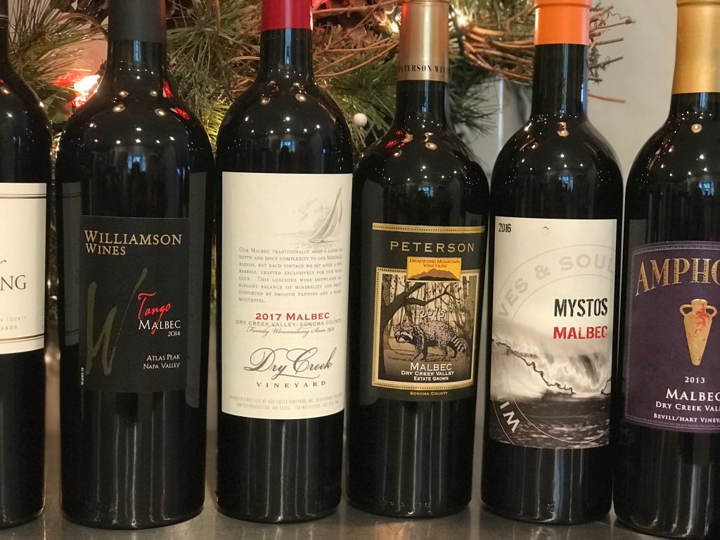 Malbec bottles on counter with Christmas wreath in background