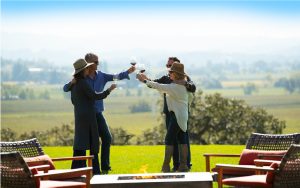 Four people toasting with wine glasses on the patio of Robert Young Estate Winery.