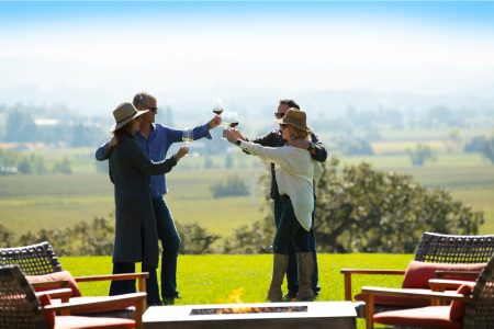 Four people toasting with wine glasses on the patio of Robert Young Estate Winery.