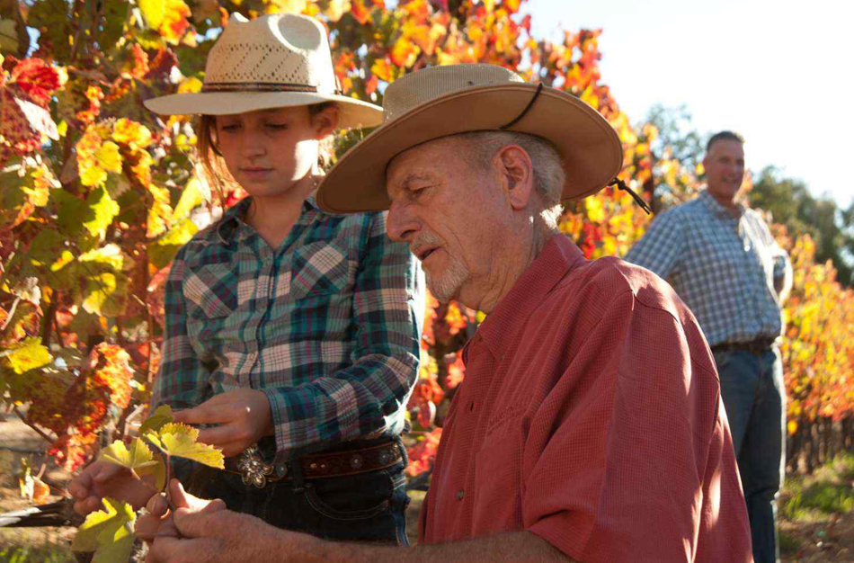 Lee Martinelli Sr working in the family vineyards with his granddaughter.
