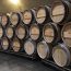Wine barrels along a cellar wall
