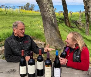 Bill and Betsy Nachbaur at a picnic table with their Acorn wines