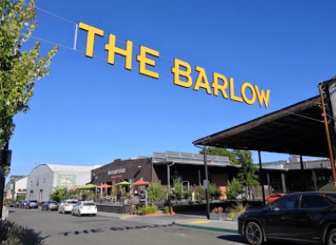 View of store fronts with The Barlow sign overhead