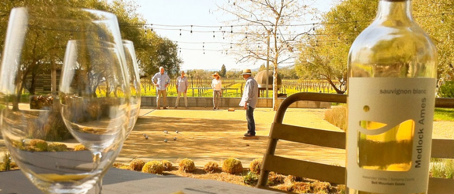 Medlock Ames tasting room with bocce courts and people playing and sipping wine