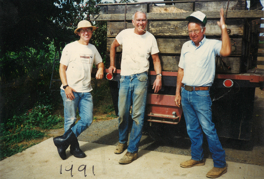 A very young Doug Nalle in 1991 standing in the back of a truck to two older men