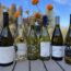 Viognier bottles on a sunny day with flowers in the background