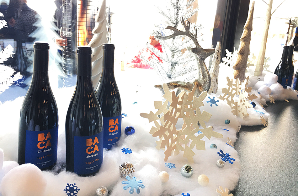 Winter scene with bottles of Baca Zinfandel as part of the display.