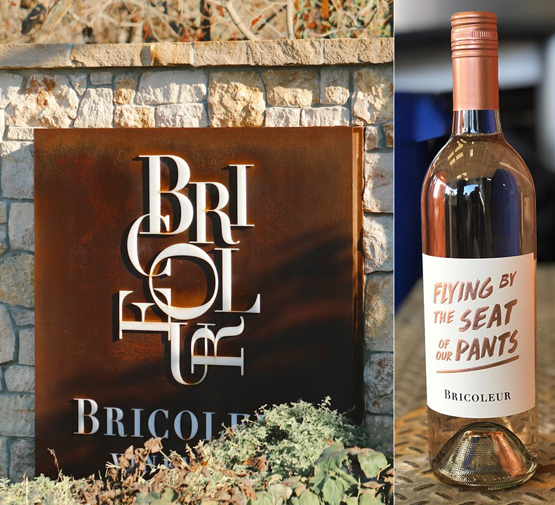 A sign with the Bricoleur logo against a stone wall, and a bottle of pink wine with a label that reads "Flying By The Seat Of Our Pants."
